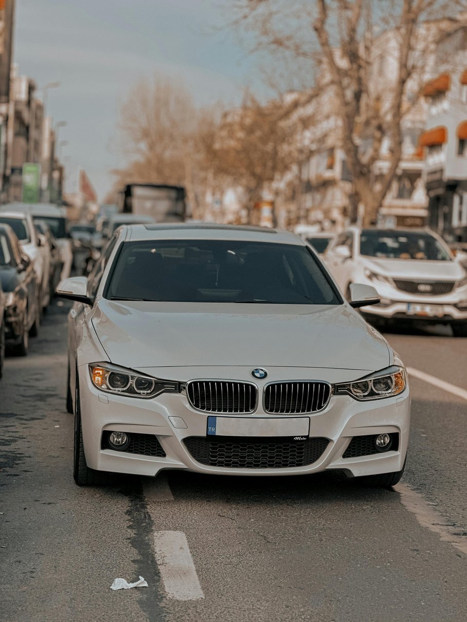 Bmw 3 series sedan in white parked on the street